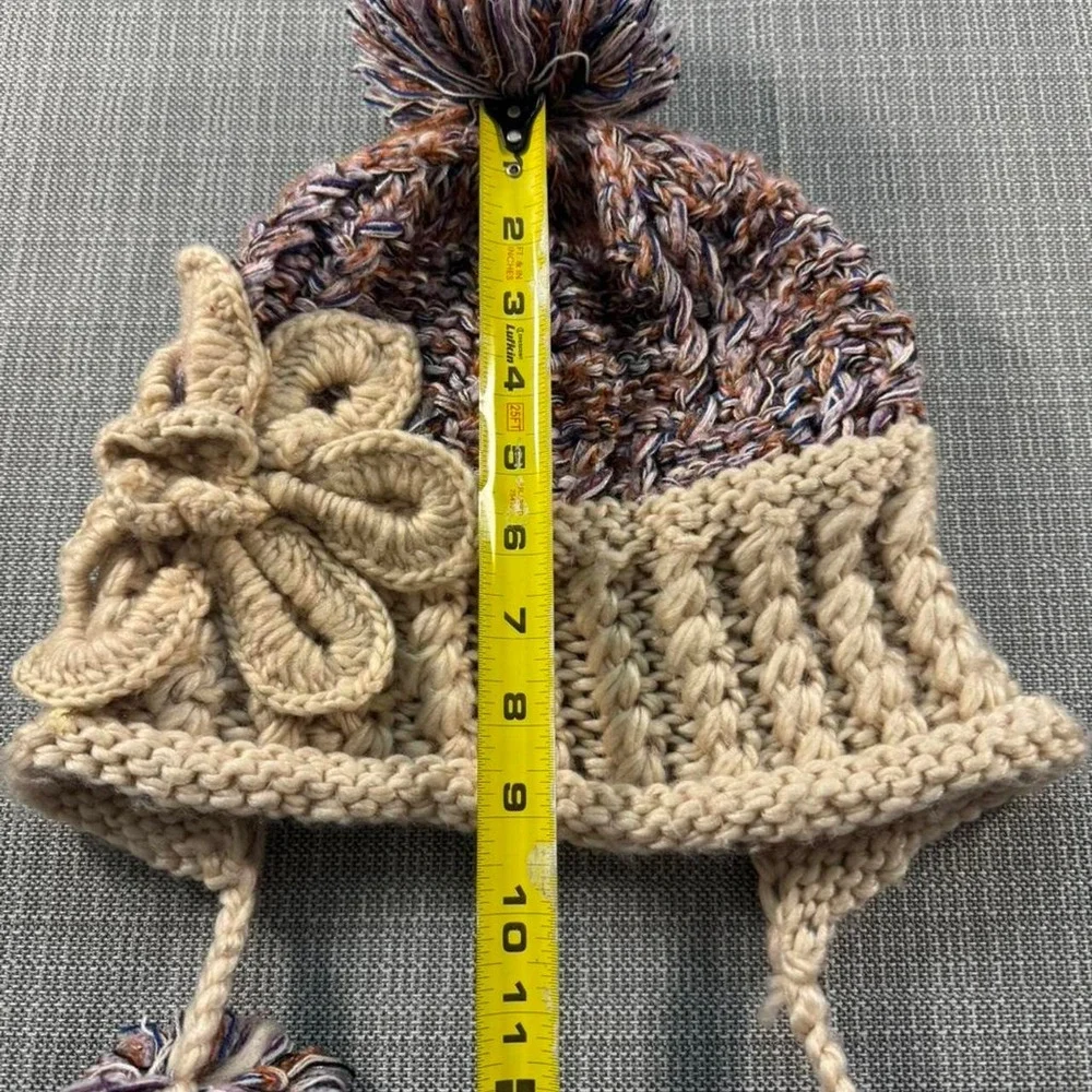 Multicolored knitted hat with pom poms
